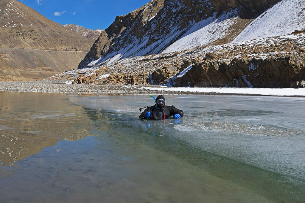 dhritiman in the frozen zanskar river near chilling